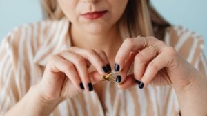 A close-up shot of a woman's hands fidgeting with stationary.