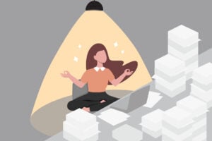 Illustration of a worker surrounded by piles of paper while meditating at the desk as a way to manage anxiety.