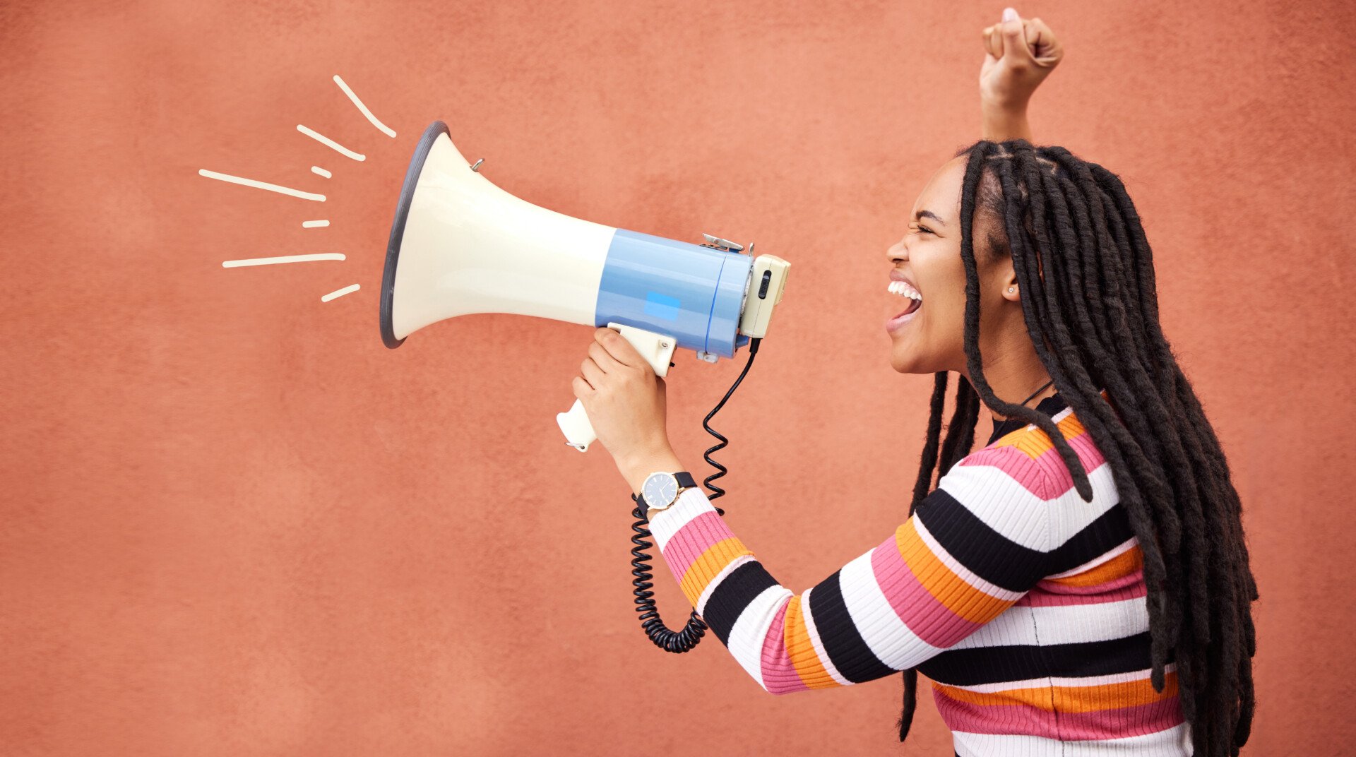 A black woman holding a megaphone and shouting into it