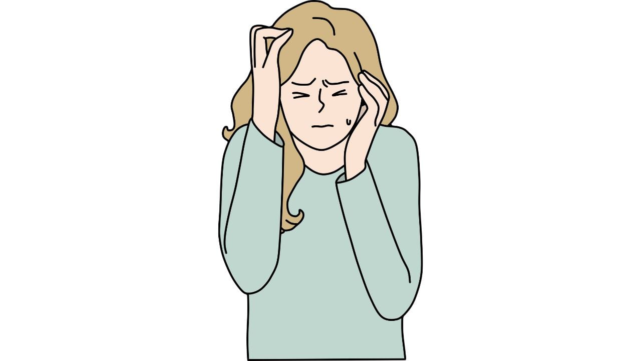 An illustration of a stressed woman holding her head.